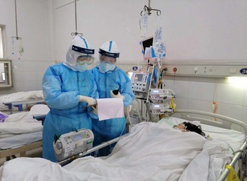 2020年2月20日，福建省对口支援宜昌防治新型冠状病毒肺炎支援队福建医大附一医院医疗队员在宜昌第三人民医院病房讨论患者病情